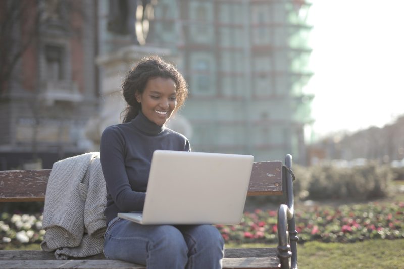woman studies at desk with laptop
